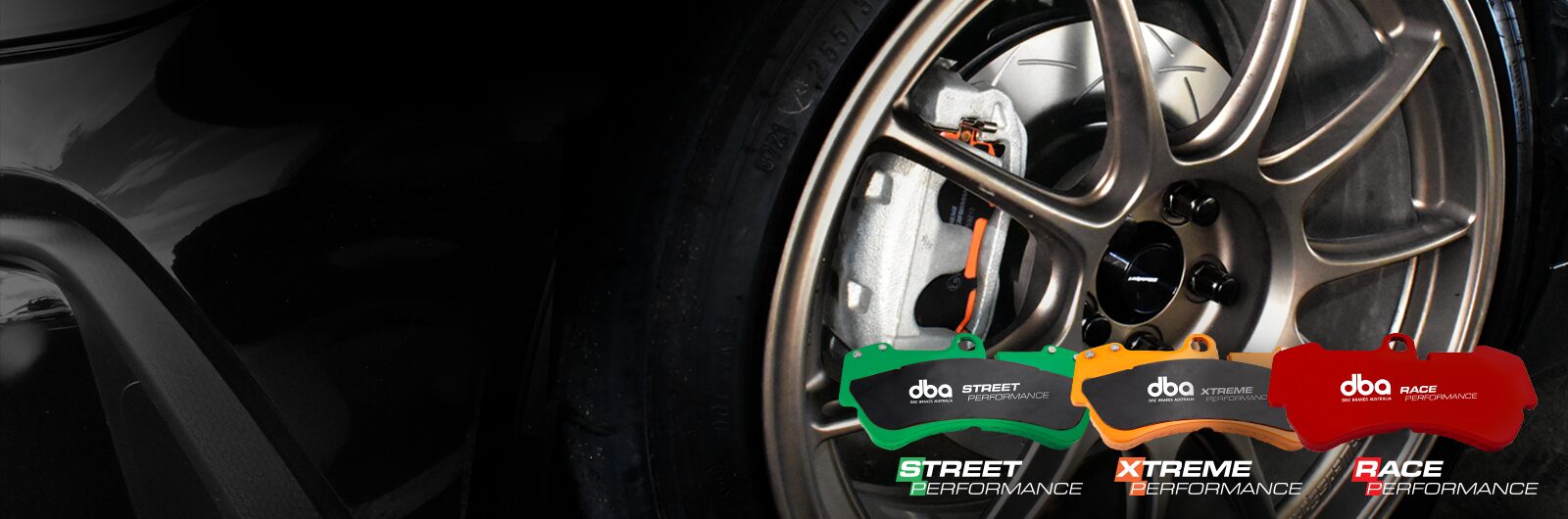 Close-up of a car wheel with dba Performance products displayed on a black background